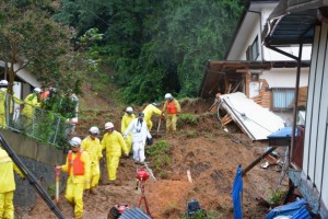Rescuers search for a missing resident in Kanuma, Tochigi prefecture, north of Tokyo Thursday, Sept. 10, 2015. Heavy rains batter Japan for the second day, causing flooding and landslides in eastern Japan. (Kyodo News via AP) JAPAN OUT, MANDATORY CREDIT
